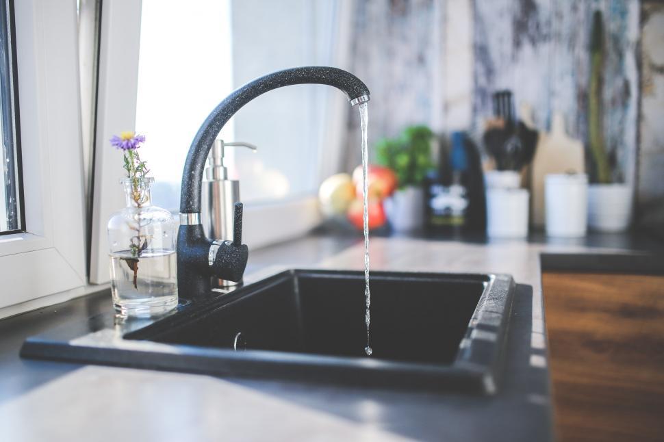 Free Image of Running Faucet in Kitchen Sink 