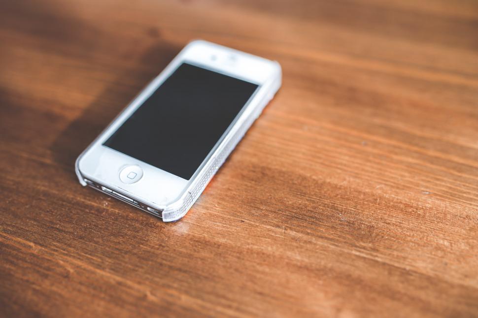 Free Image of White Cell Phone on Wooden Table 
