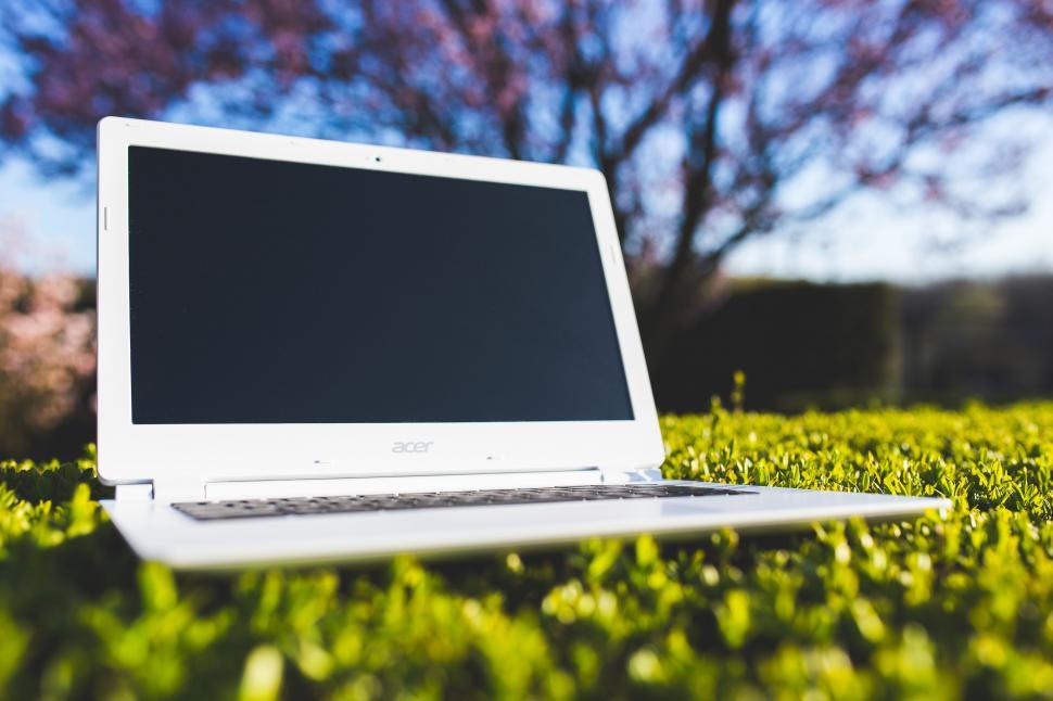 Free Image of Laptop Computer on Lush Green Field 