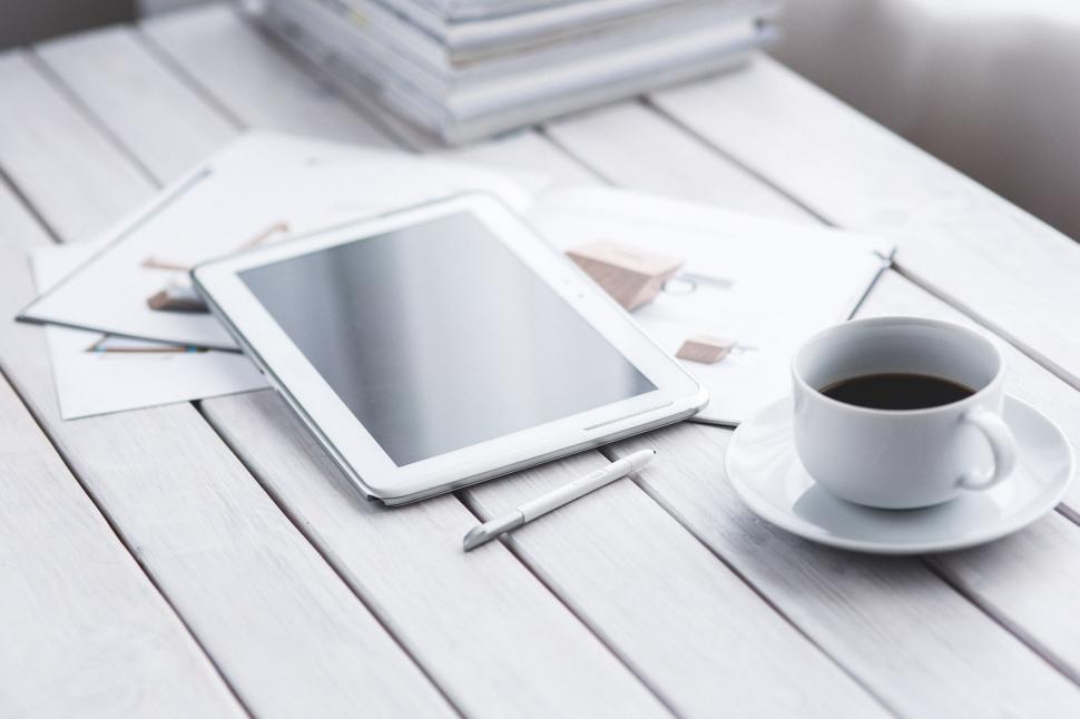 Free Image of Tablet and Coffee Cup on Table 