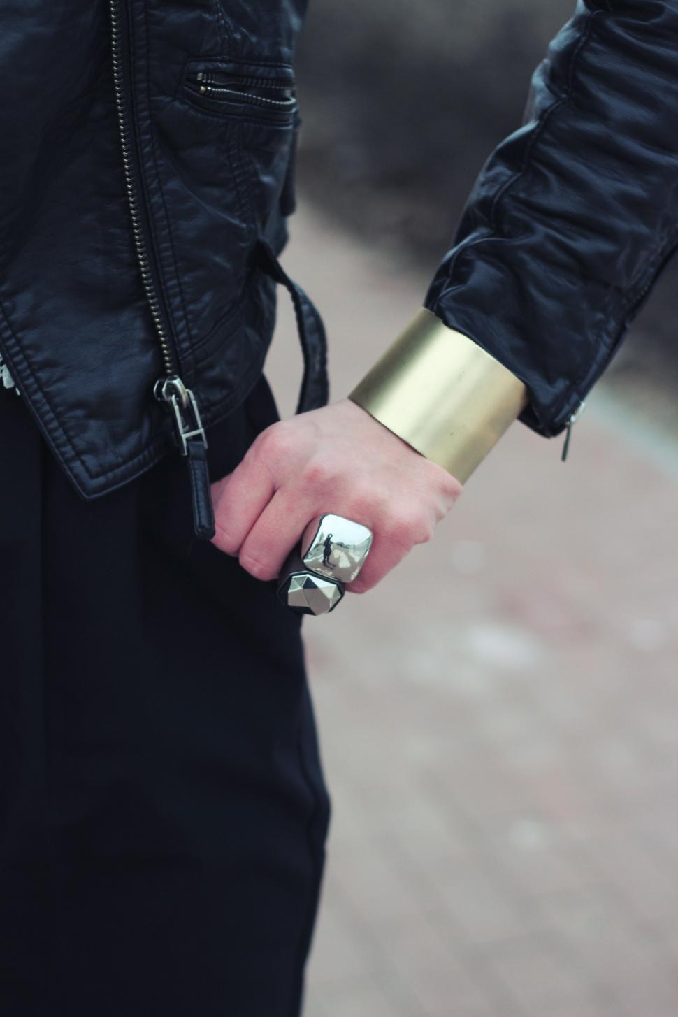 Free Image of Man Holding Silver Object in Black Jacket 