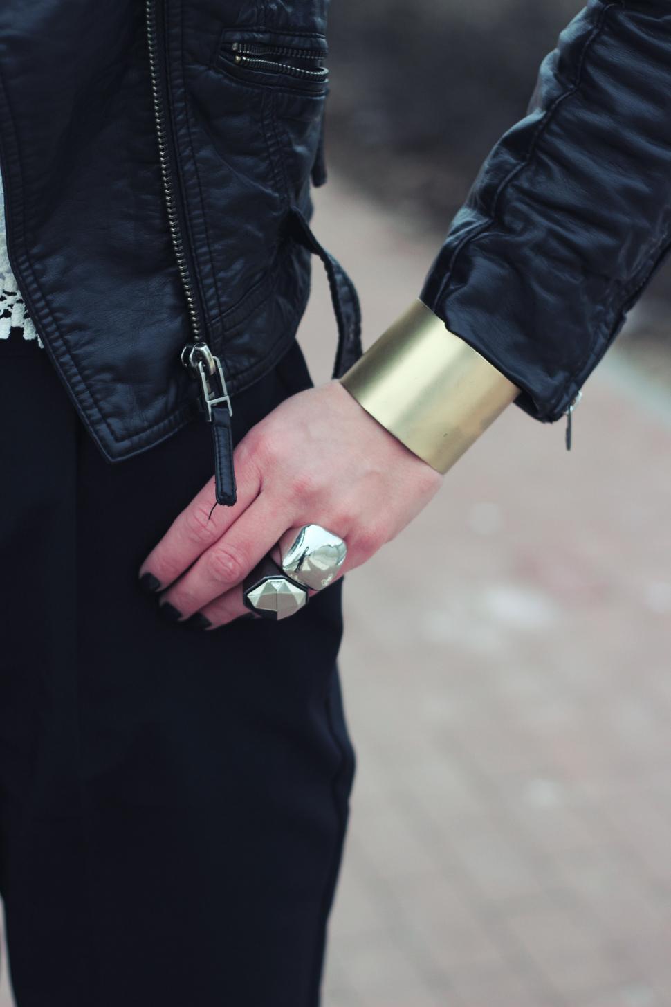 Free Image of Person Wearing Black Jacket and Gold Ring 