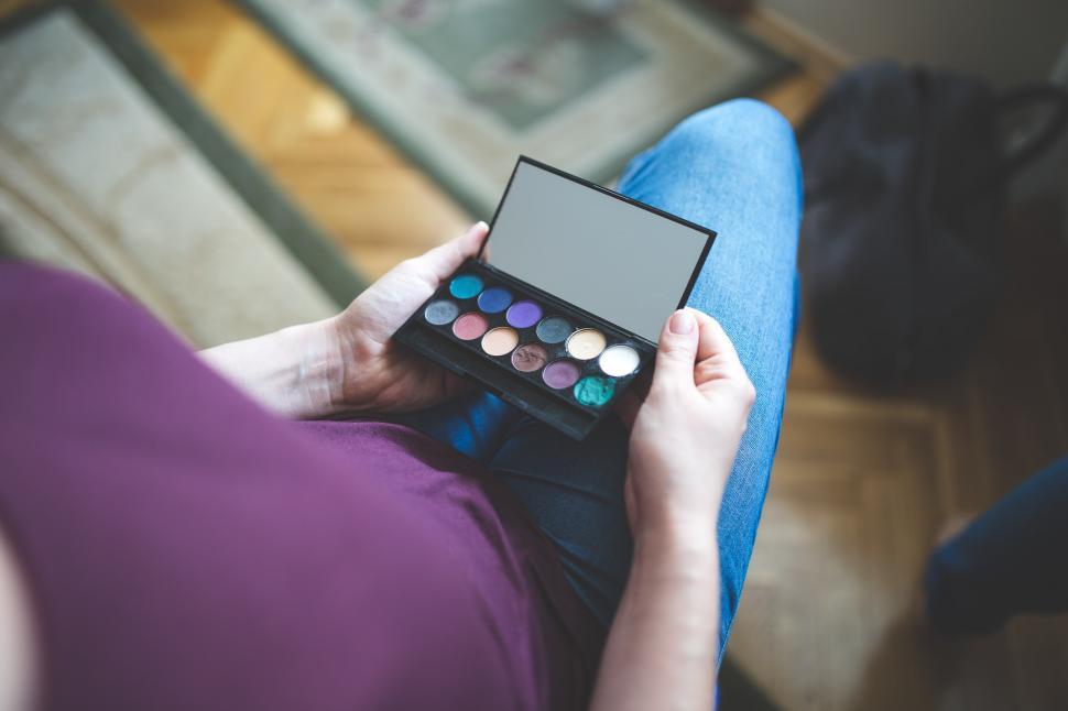 Free Image of Woman Holding a Palette of Makeup 