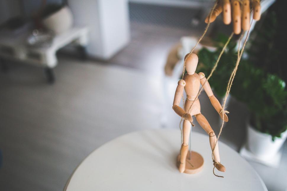 Free Image of Small Wooden Figure Hanging on Rope 