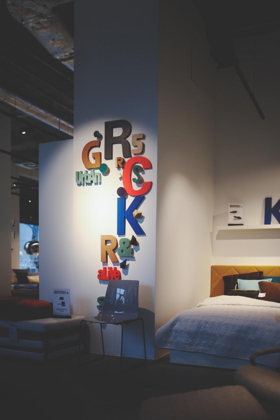 Free Image of Bed in Room With Wall Letters 