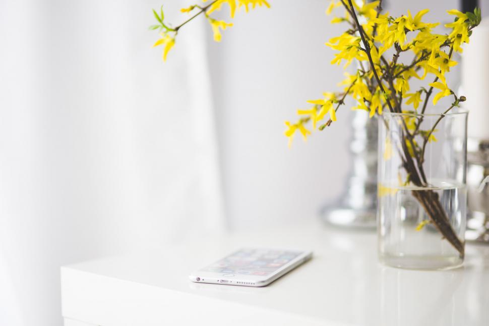 Free Image of Vase of Yellow Flowers on White Table 
