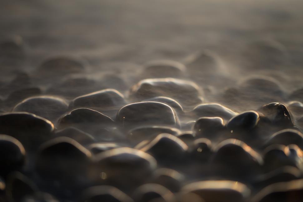 Free Image of Small Stones Washed By Ocean Waves  