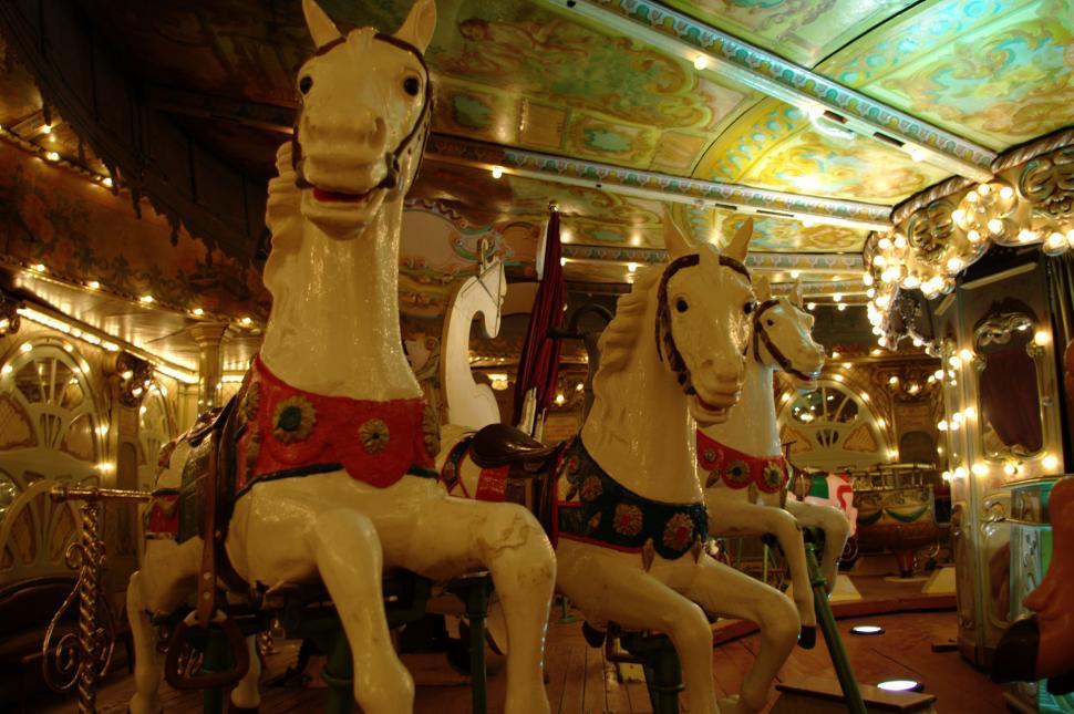 Free Image of Group of Horses Sitting on Top of Carousel 