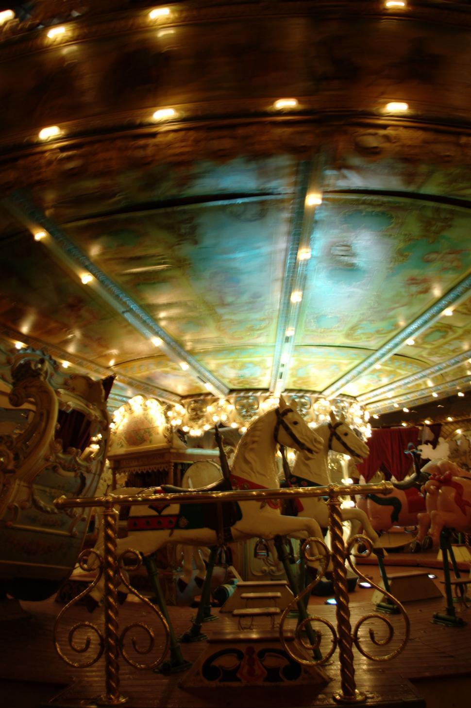 Free Image of A Vibrant Merry Go Round With Lights and Horses 