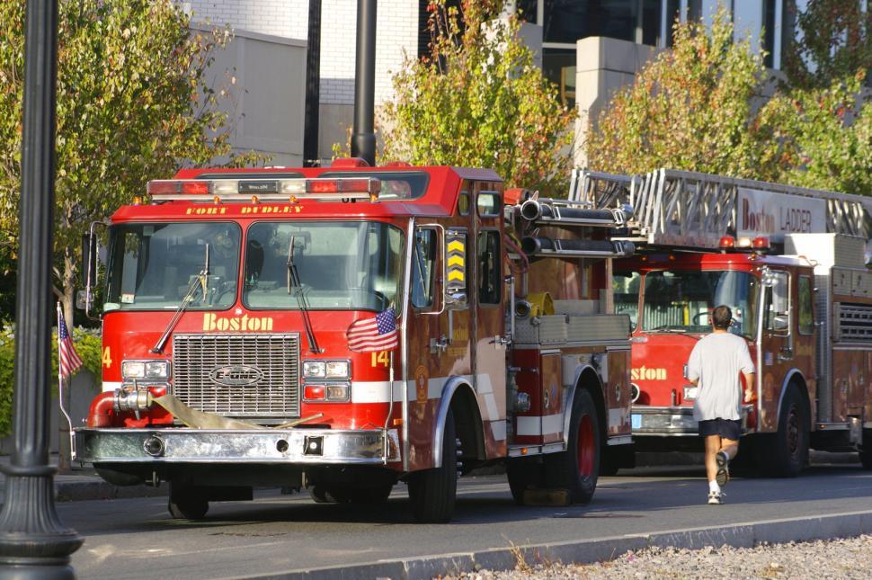 Free Image of Two Fire Trucks Racing Down a Street 