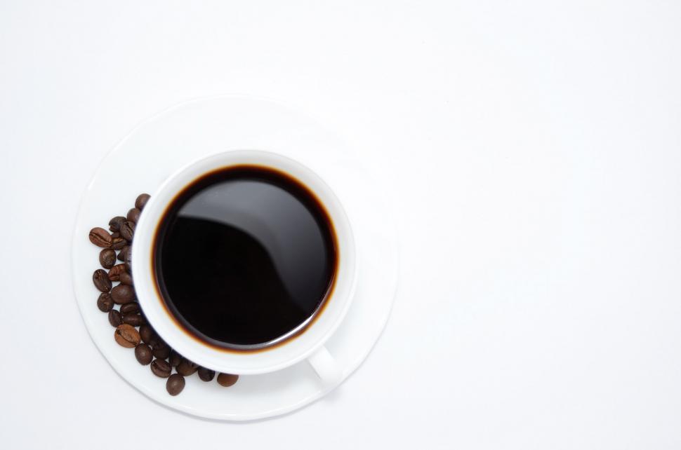 Free Image of A Cup of Coffee With Beans on a Saucer 