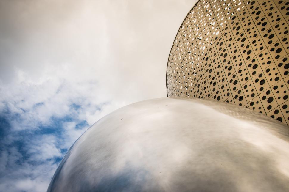Free Image of Close Up of Metal Object With Clouds in the Background 