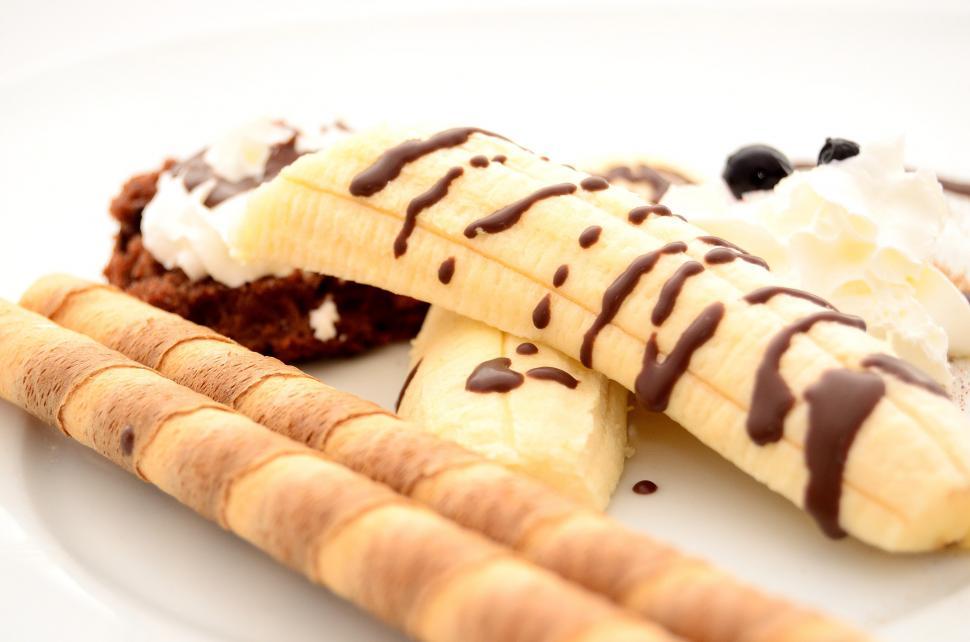 Free Image of White Plate With Banana Slices and Ice Cream 