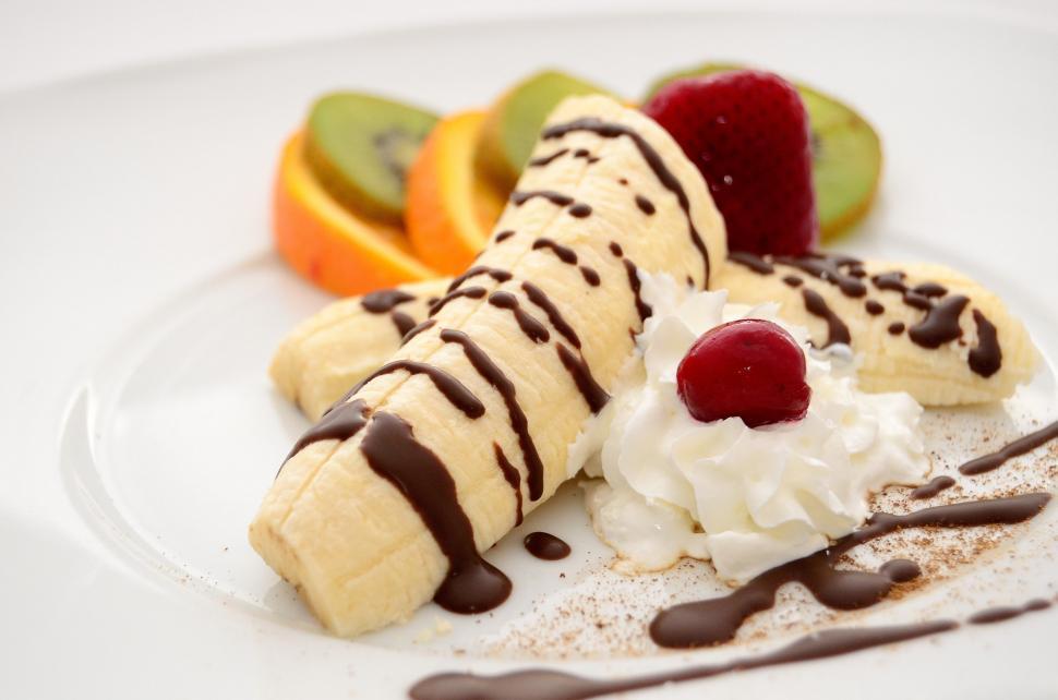 Free Image of White Plate With Banana Split and Whipped Cream 