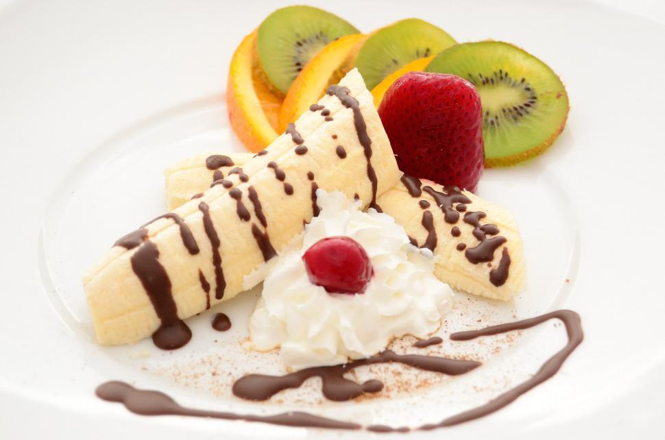 Free Image of Banana Split With Whipped Cream on a White Plate 