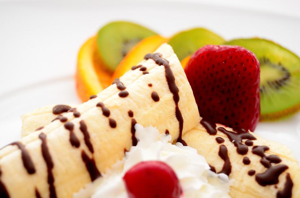 Free Image of Delicious Banana Split With Whipped Cream and Fresh Fruit 