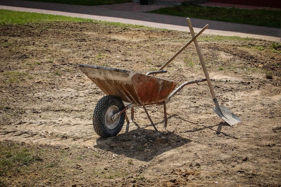 Free Image of Wheelbarrow Sitting in Dirt 