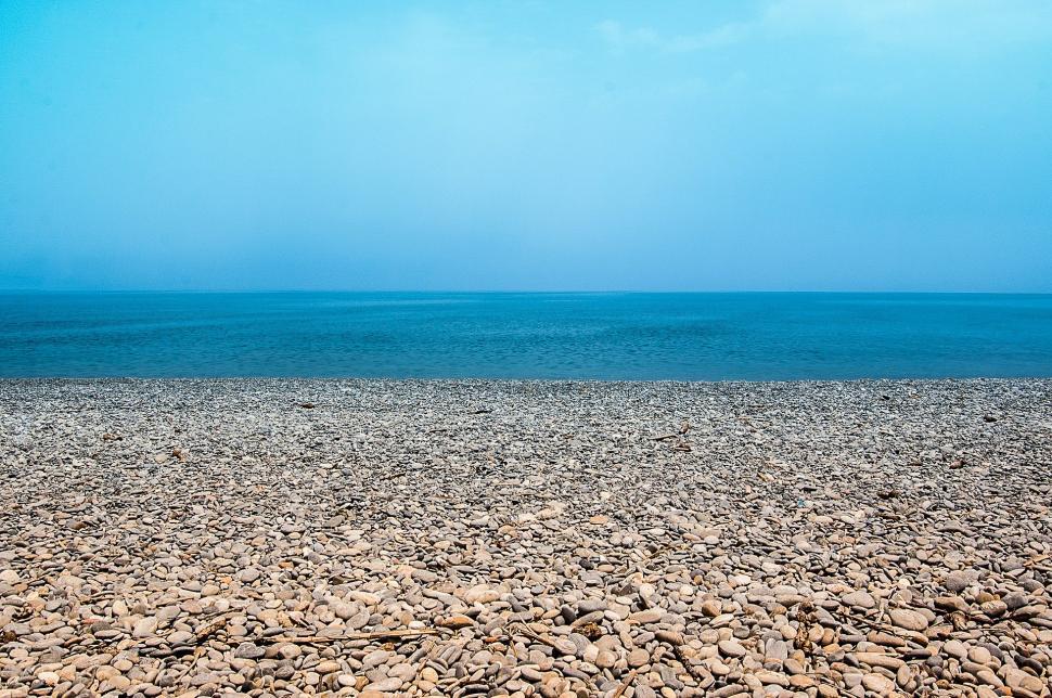 Free Image of Large Body of Water Next to Sandy Beach 