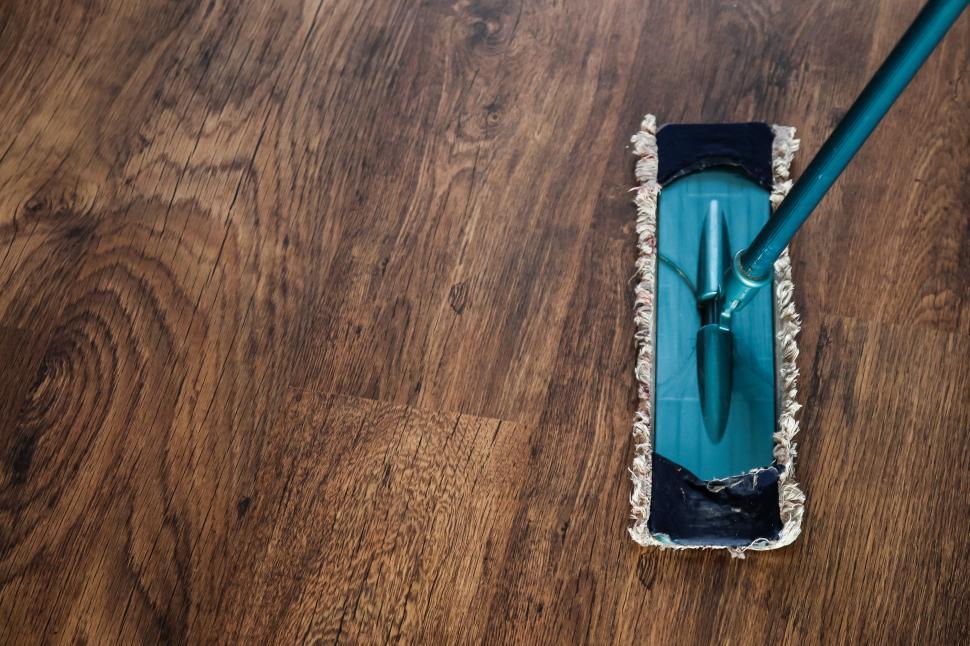Free Image of A Mop Resting on a Wooden Floor 