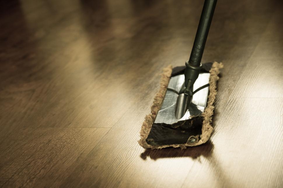 Free Image of A Mop Resting on a Wooden Floor 