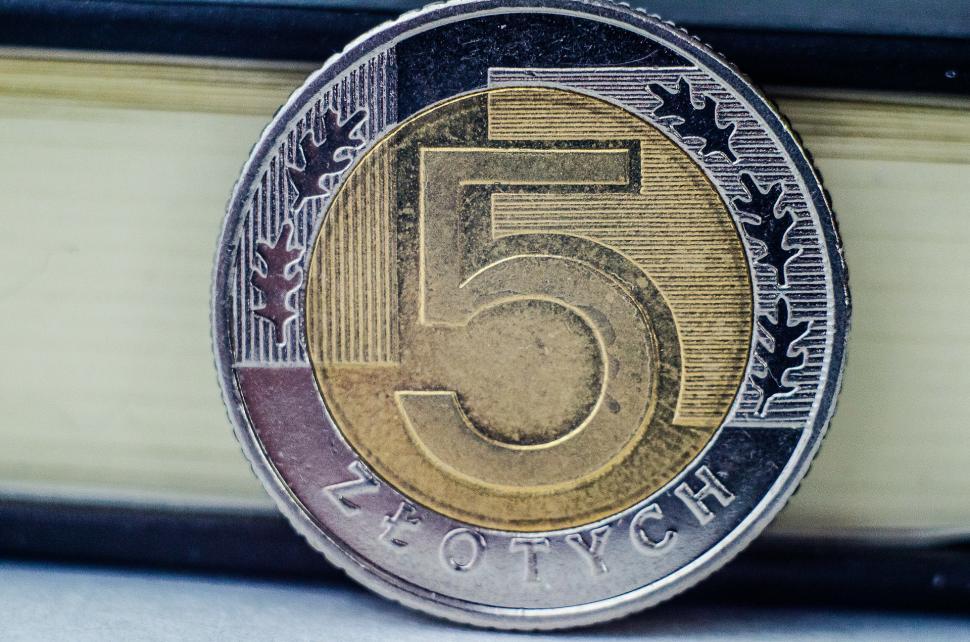Free Image of Five Euro Coin Resting on Top of a Book 