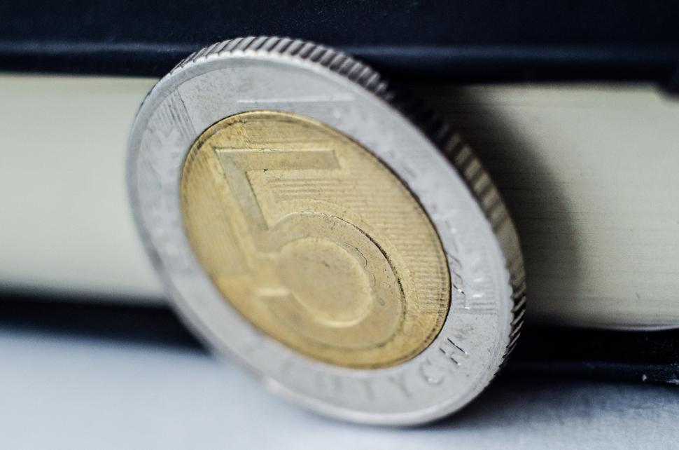 Free Image of Five Euro Coin on Top of Paper 