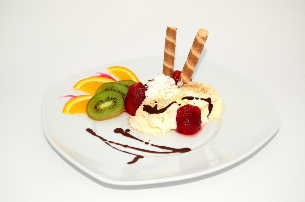 Free Image of White Plate Topped With Ice Cream and Fruit 