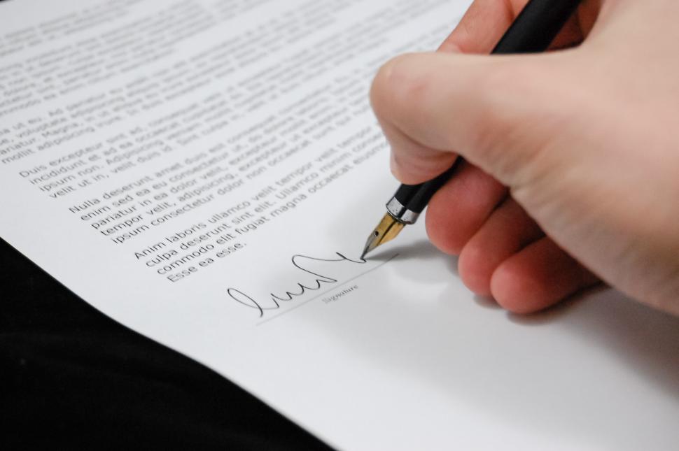Free Image of Person Writing on Piece of Paper With Pen 