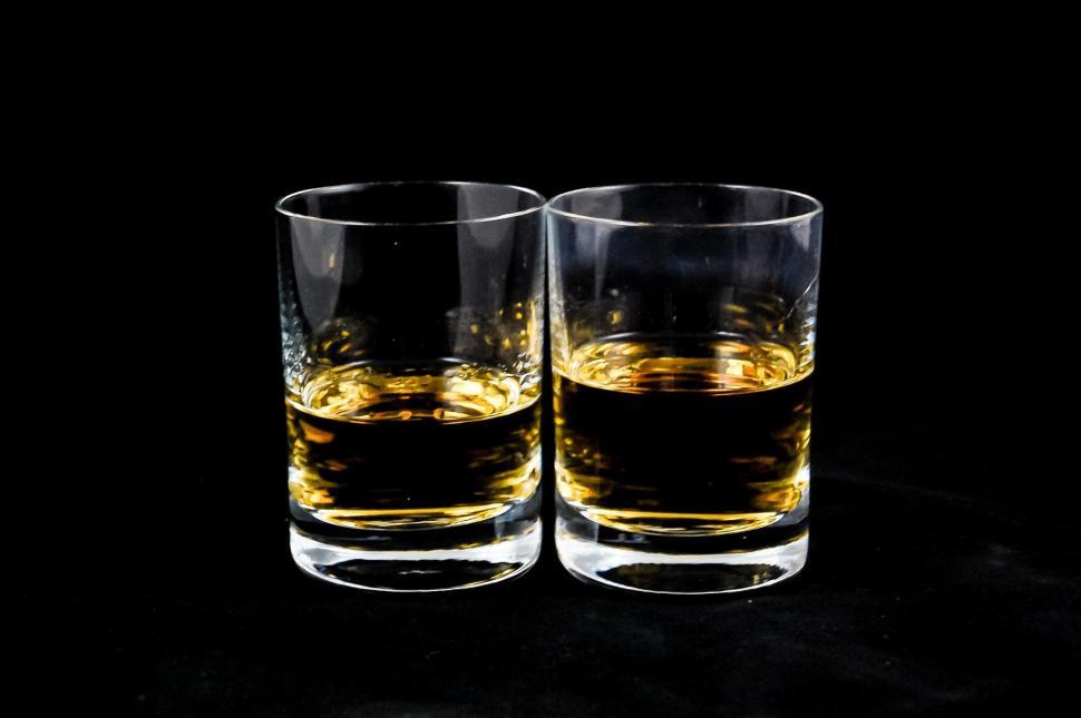 Free Image of Two Glasses of Whiskey on a Black Background 