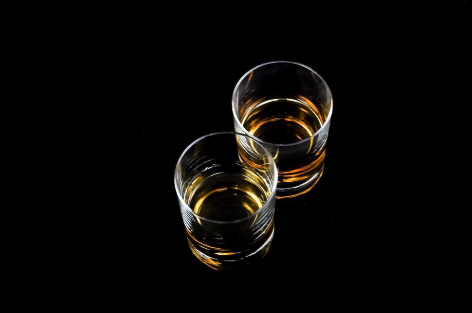 Free Image of Two Glasses of Whiskey on a Black Background 