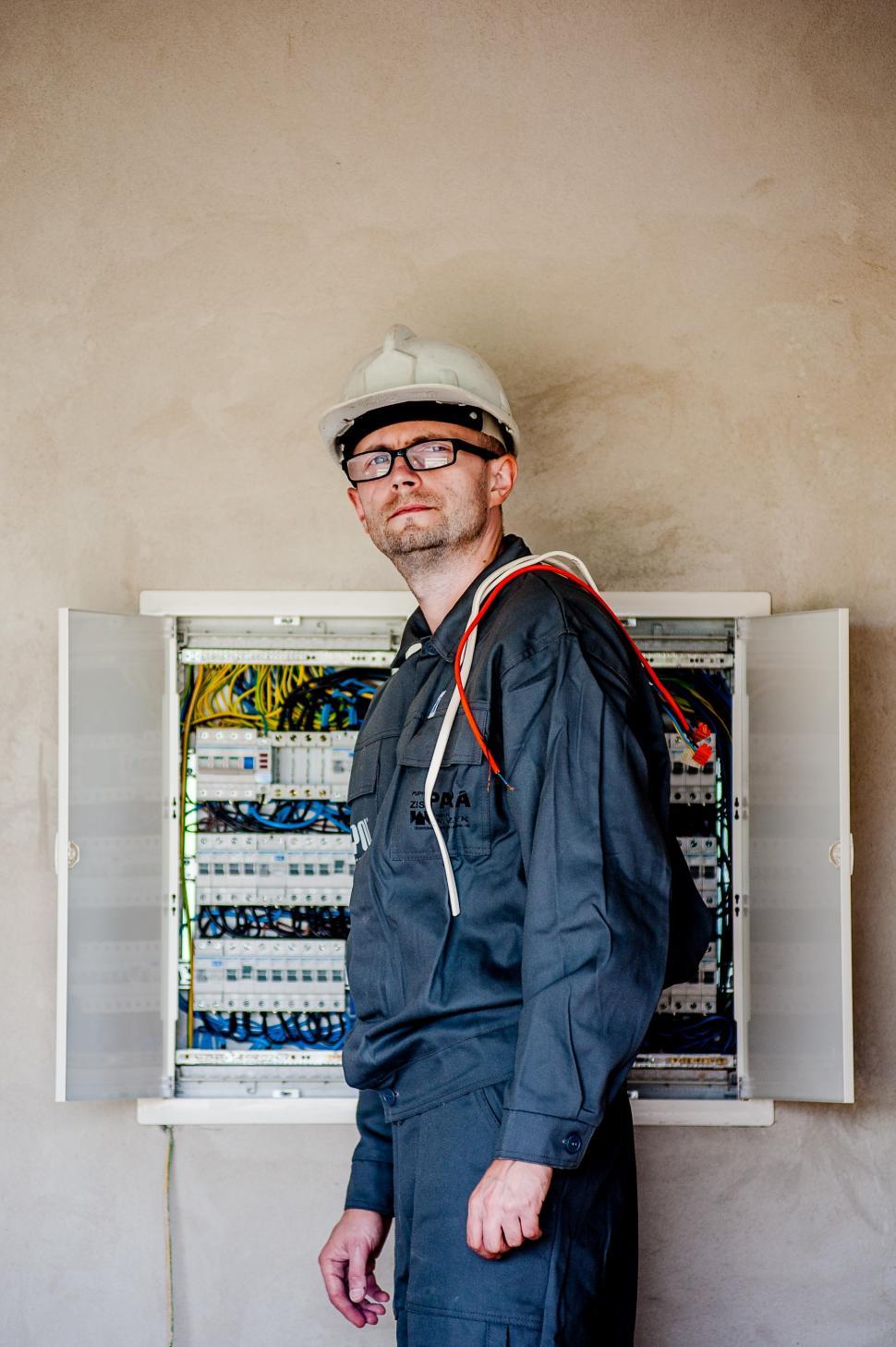 Free Image of Man in Hard Hat and Glasses at Electrical Panel 