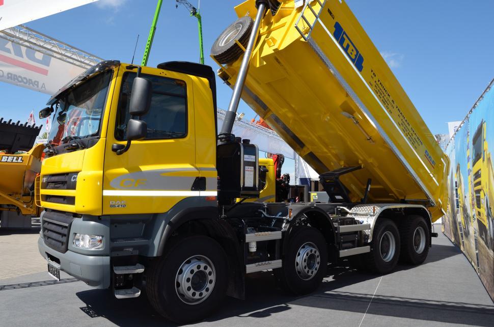Free Image of Large Yellow Dump Truck Parked in Parking Lot 