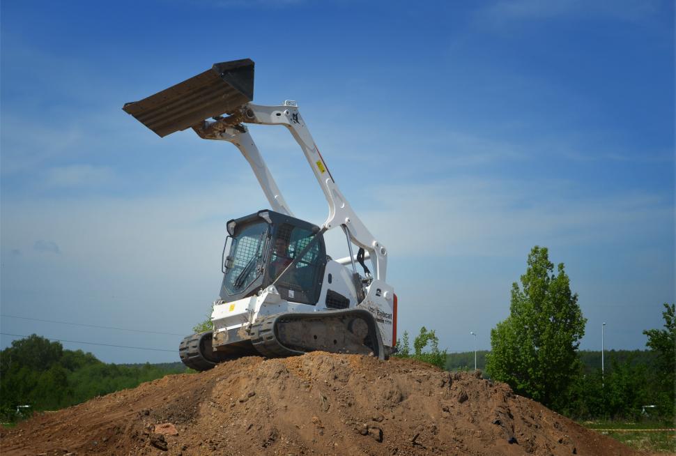 Free Image of Bulldozer Digging Through Pile of Dirt 