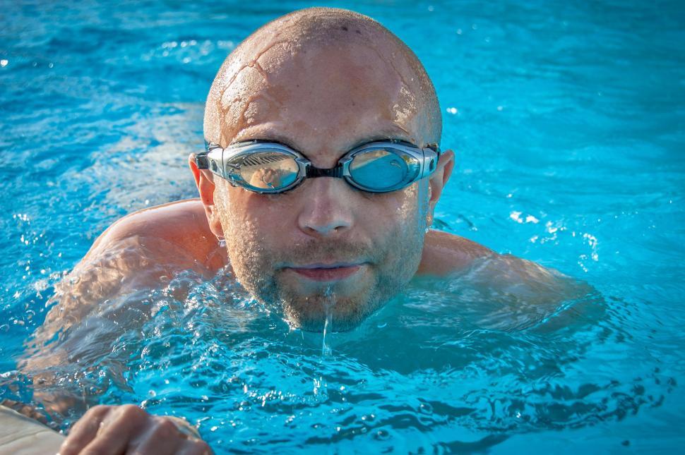 Free Image of Man Swimming in Pool With Goggles 