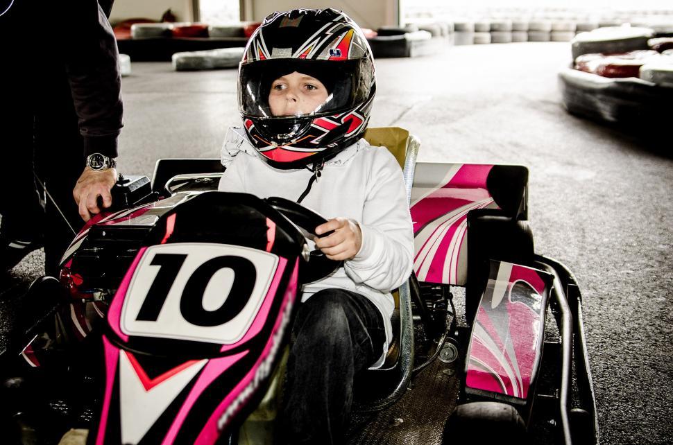 Free Image of Young Boy Sitting in a Go Kart With Helmet On 