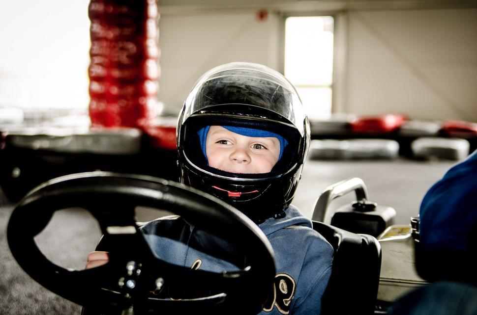 Free Image of Young Boy Wearing Helmet Sitting in Car 