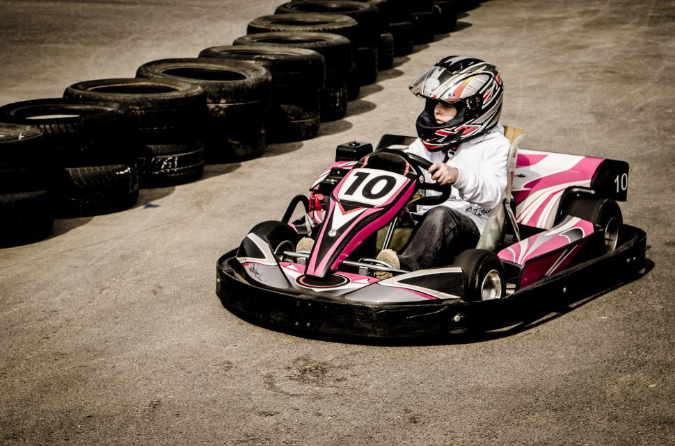 Free Image of Person Riding Go Kart in Parking Lot 