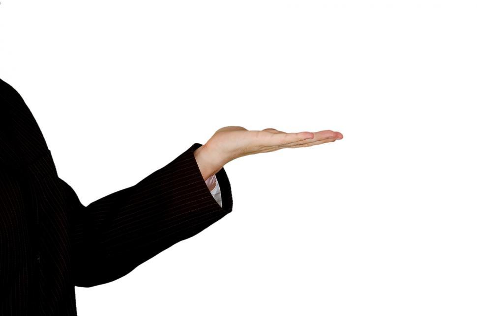 Free Image of Man in Black Suit Holding Out His Hand 