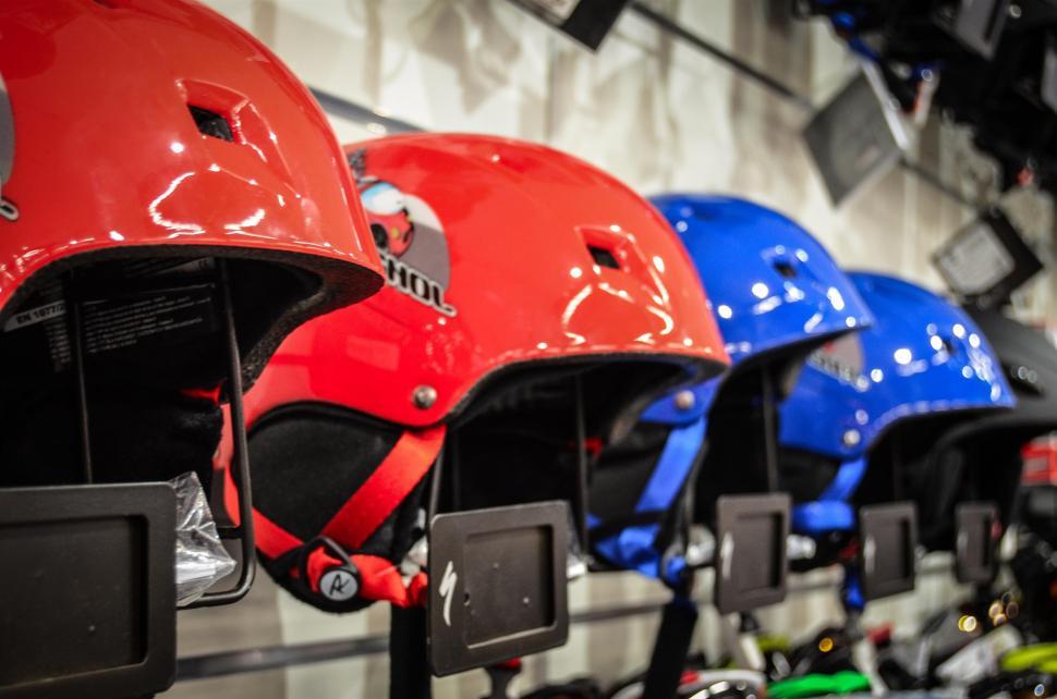 Free Image of Row of Red, Blue, and Yellow Helmets on Display 