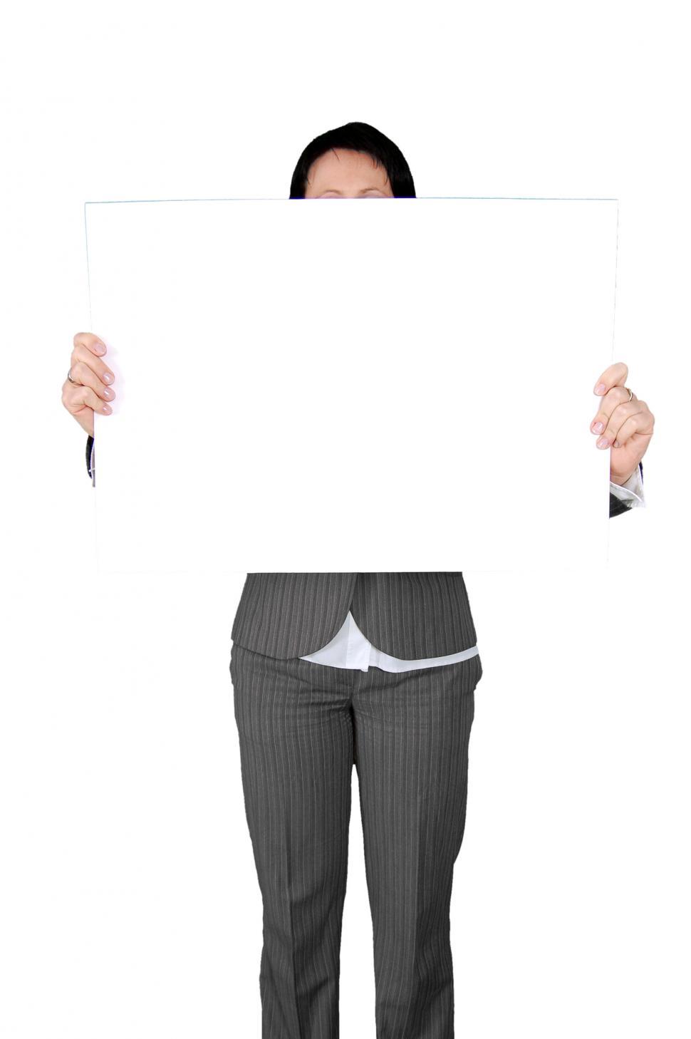 Free Image of Woman in a Suit Holding Up a Sign 