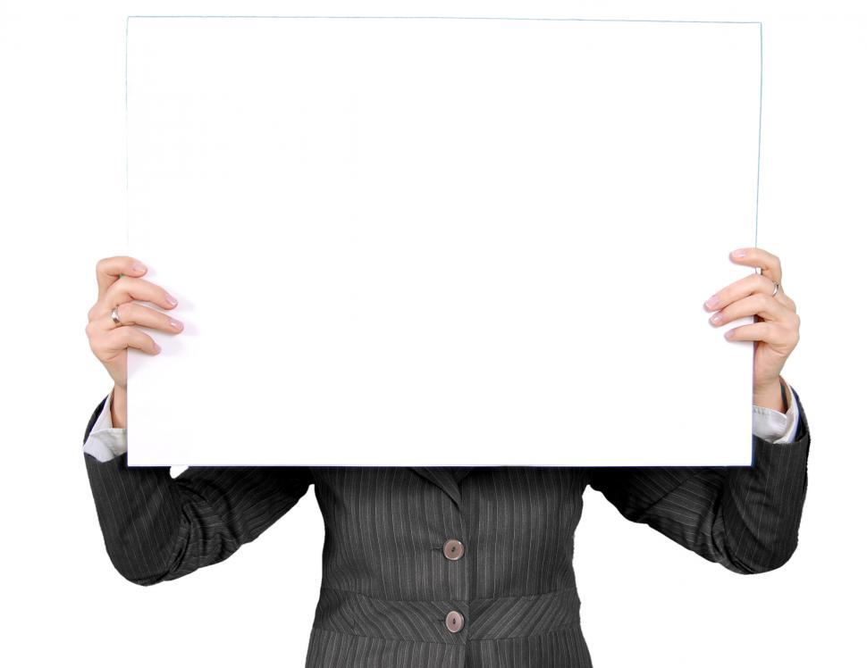 Free Image of Woman in Suit Holding Up White Board 