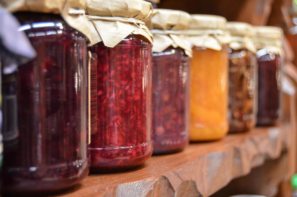 Free Image of Shelf With Jars Filled With Various Colored Liquids 