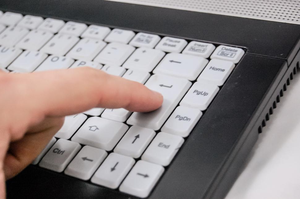 Free Image of Person Pressing Button on Computer Keyboard 