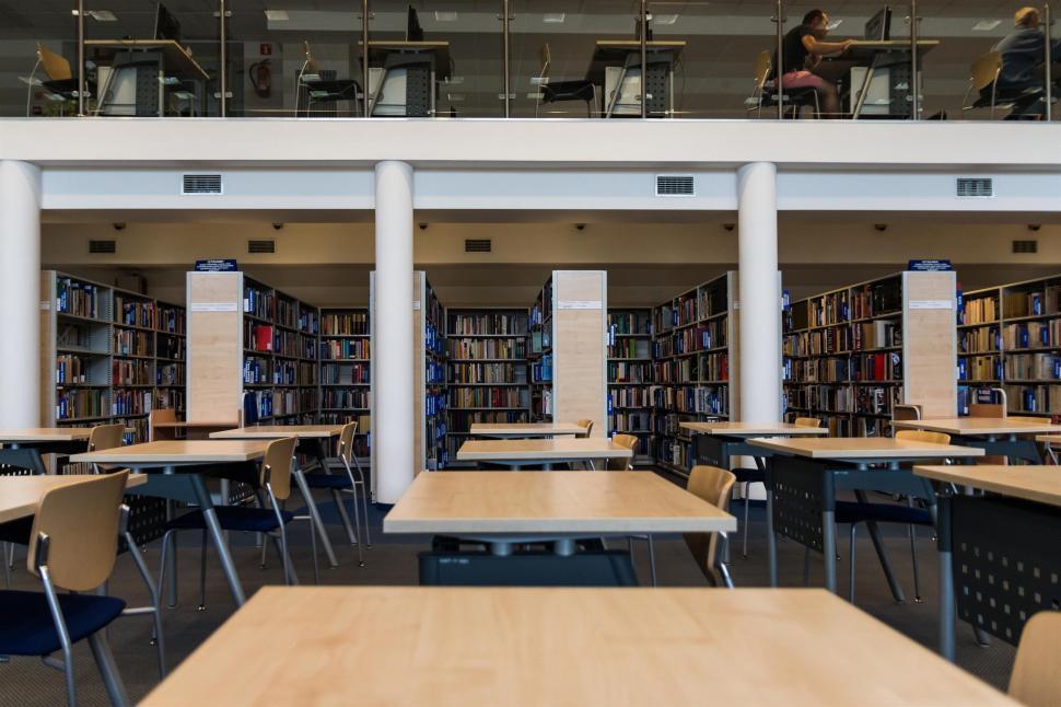 Free Image of Library Filled With Wooden Tables and Chairs 
