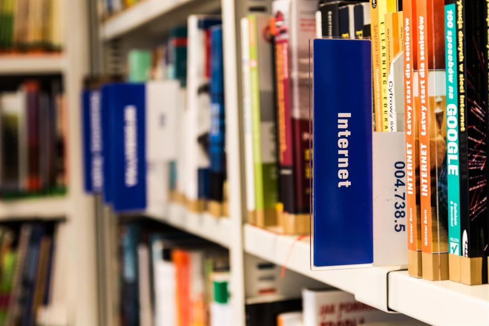 Free Image of A Row of Books on a Shelf in a Library 