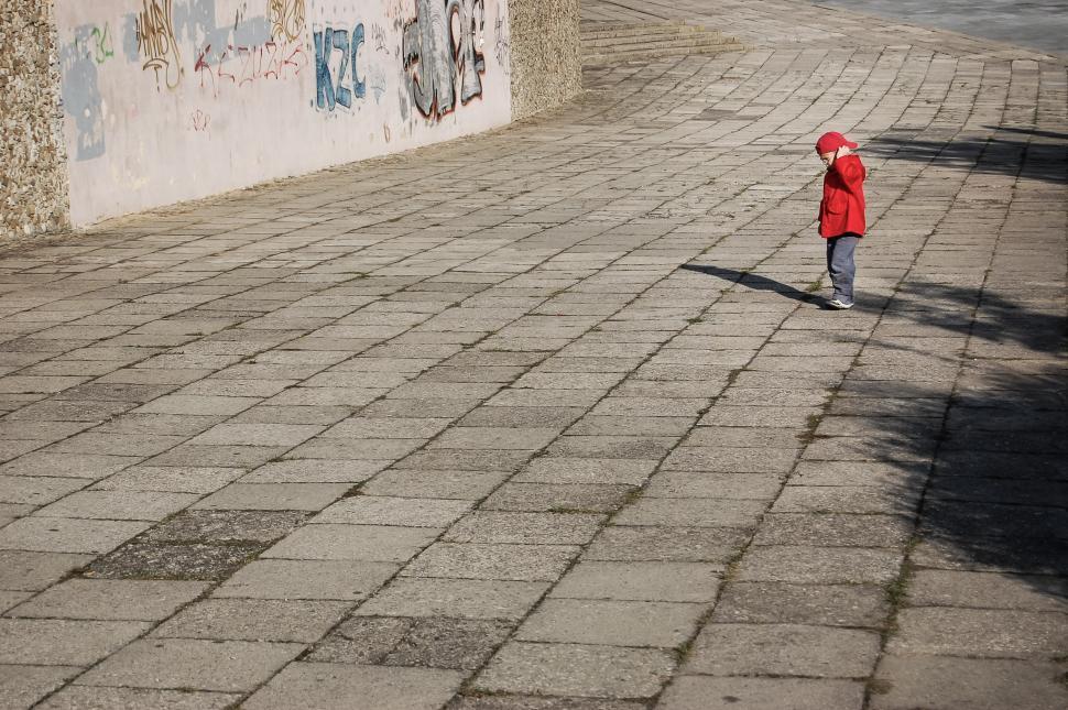 Free Image of Little Boy in Red Jacket Walking Down the Street 
