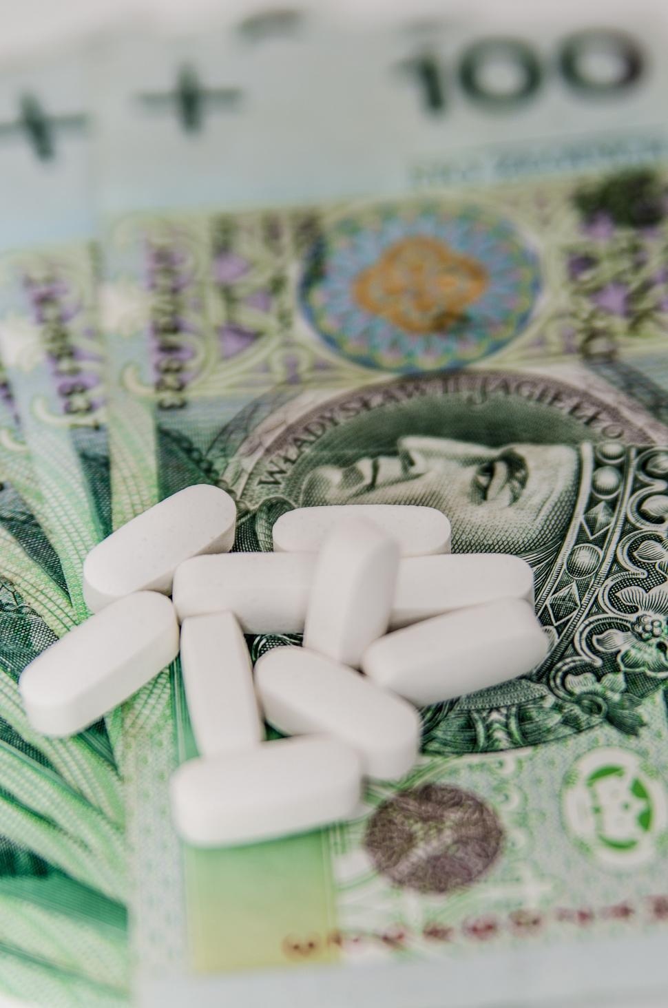 Free Image of Pills Stacked on Money 