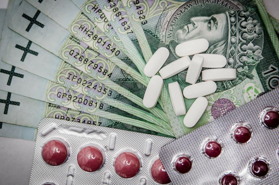 Free Image of Pills on Money Stack 