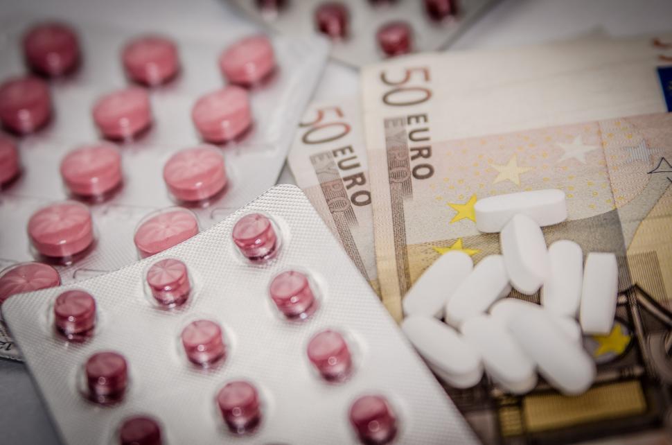 Free Image of Pills on Top of Money Stack 