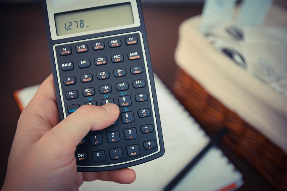 Free Image of Person Holding a Calculator 